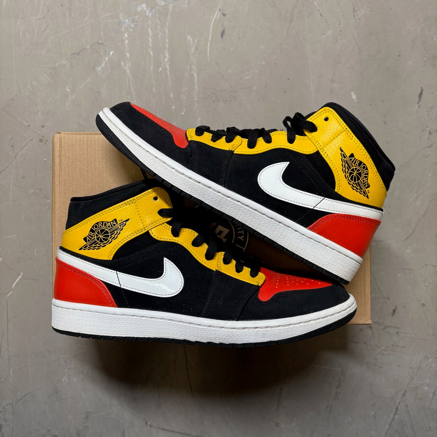 Jordan 1 Mid Black Amarillo Orange